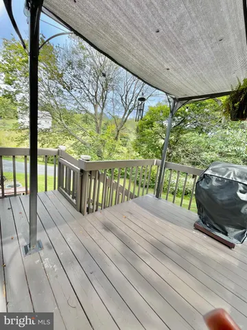 a view of a balcony with wooden floor