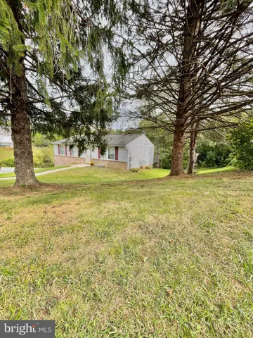 a view of yard with swimming pool and trees