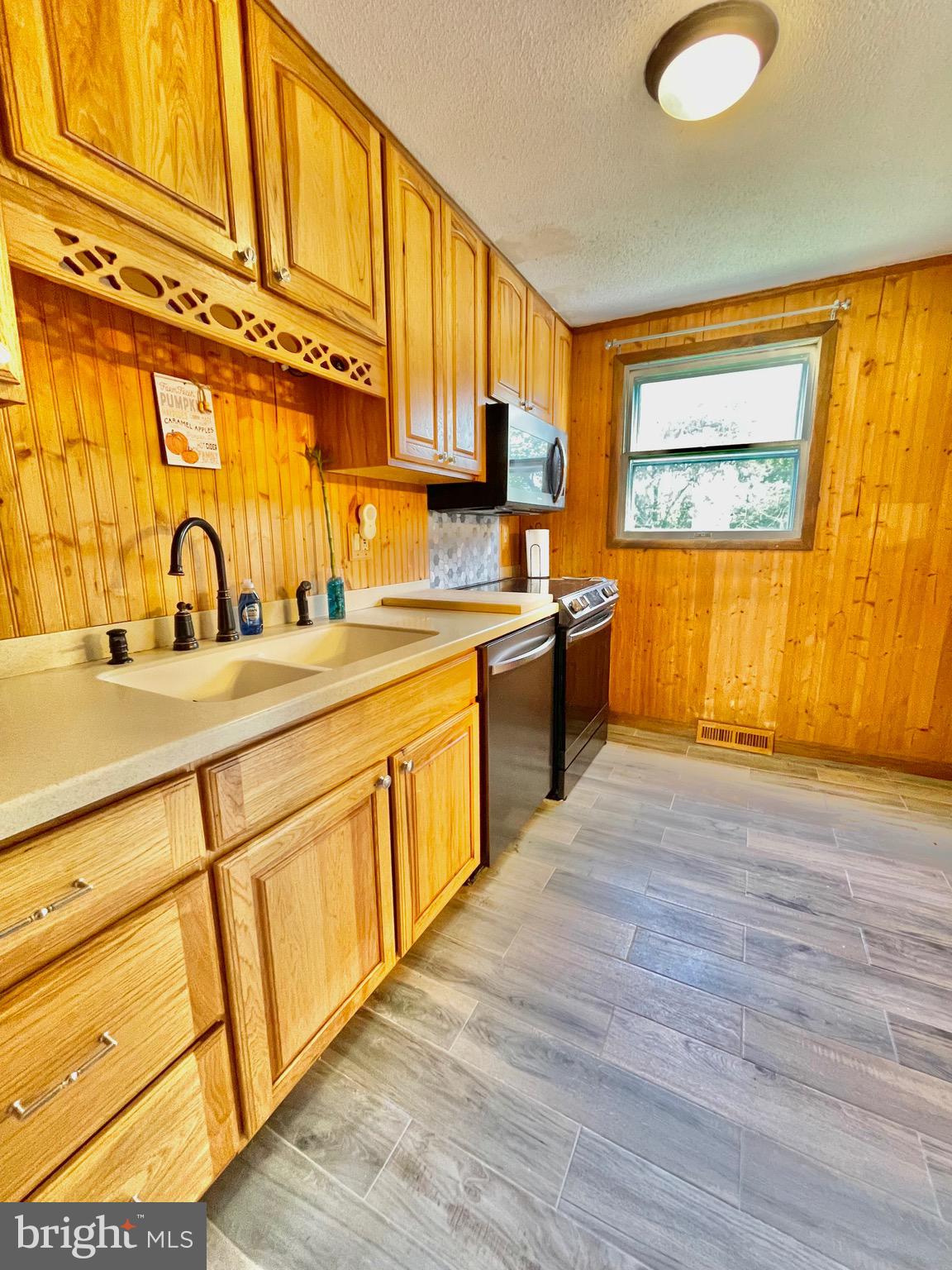 1 Valley View Road York, PA 17403 - Photo 9 of 40 a kitchen with stainless steel appliances granite countertop a sink cabinets and wooden floor