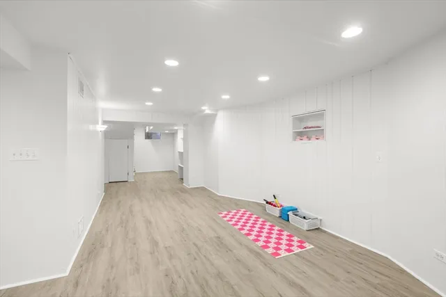 a view of hallway with wooden floor