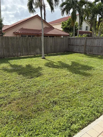 a view of a backyard with a fence