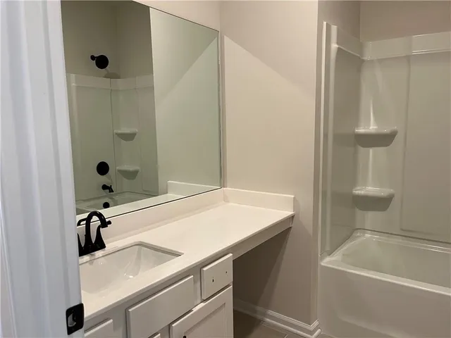 a view of a small space with wooden floor and a window