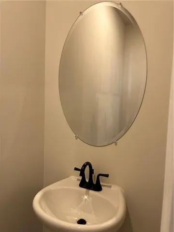 a bathroom with a sink and mirror
