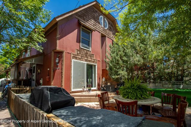 a view of a house with a backyard and sitting area