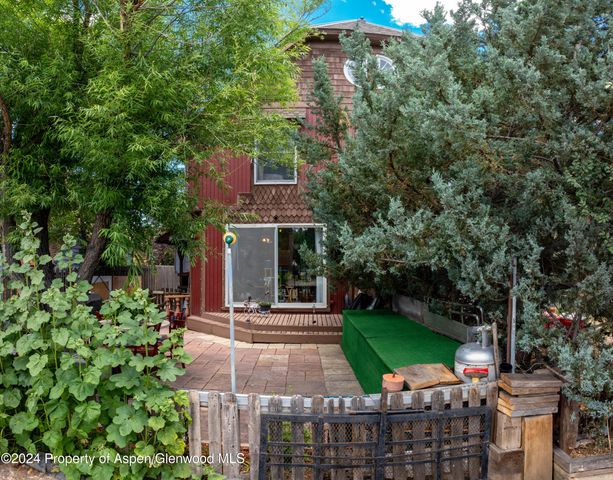 a view of a patio with a table and chairs and potted plants