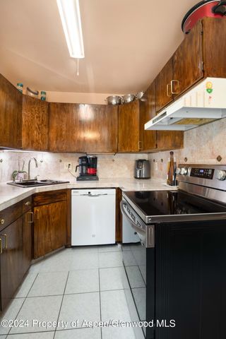 a kitchen with a sink a stove and cabinets