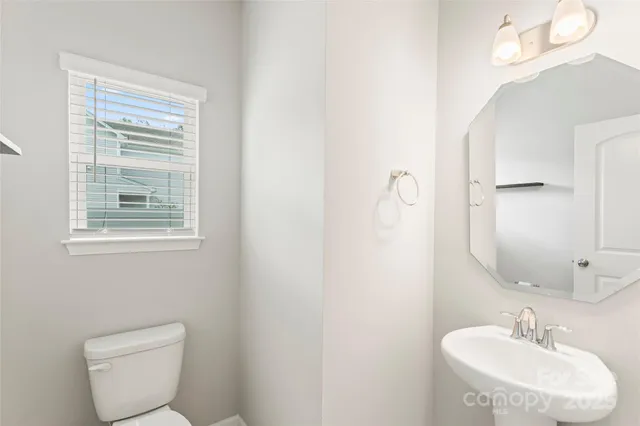 a bathroom with a sink a mirror and a window