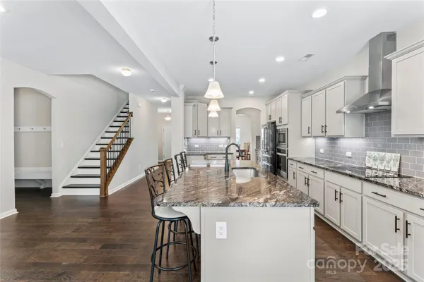 a kitchen with kitchen island stainless steel appliances lots of counter top space
