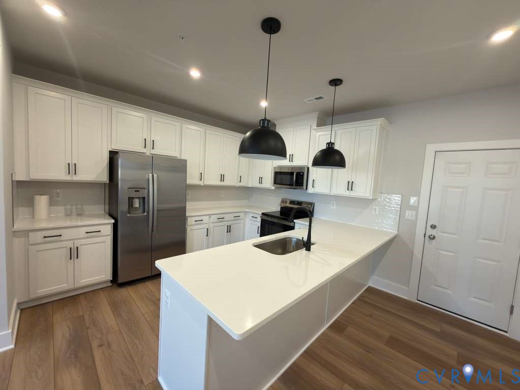 3605 Edna Path, Unit A Henrico, VA 23233 - Photo 4 of 20 a kitchen with stainless steel appliances granite countertop a sink a stove and refrigerator