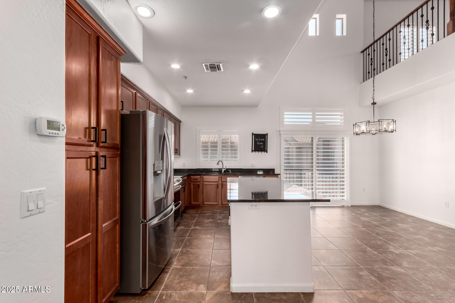 3935 East Rough Rider Road, Unit 1076 Phoenix, AZ 85050 - Photo 14 of 48 a large kitchen with stainless steel appliances a refrigerator and a stove top oven