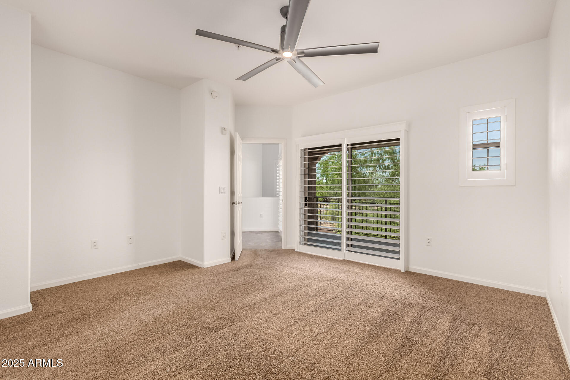 3935 East Rough Rider Road, Unit 1076 Phoenix, AZ 85050 - Photo 15 of 48 an empty room with windows closet and fan