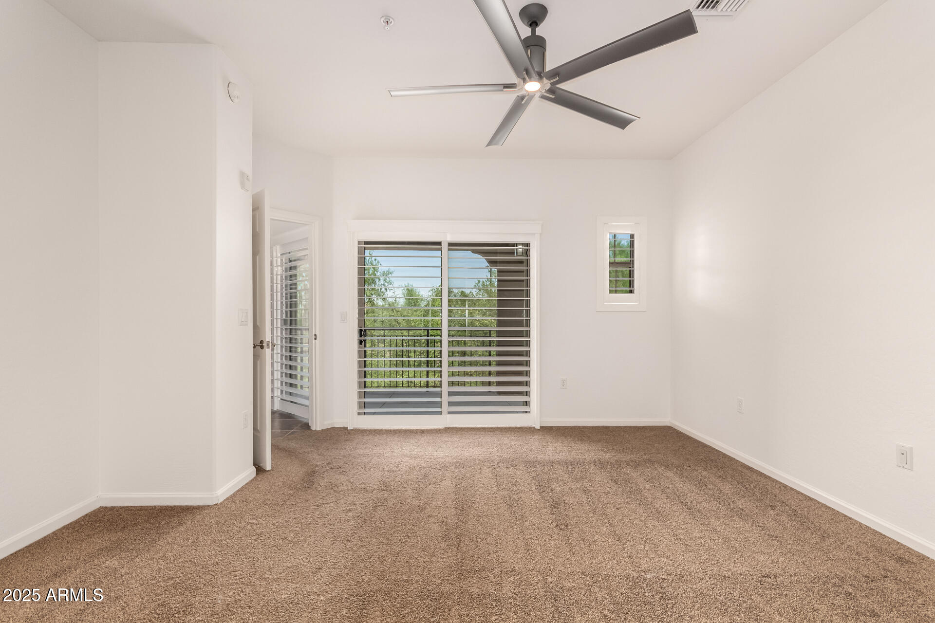 3935 East Rough Rider Road, Unit 1076 Phoenix, AZ 85050 - Photo 17 of 48 an empty room with windows and fan