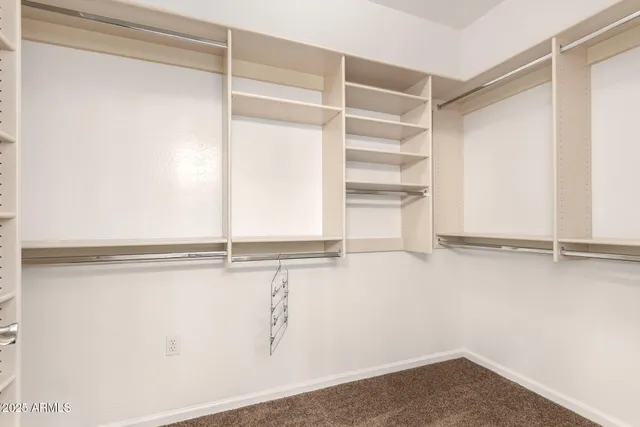 an empty room with a ceiling fan and a window