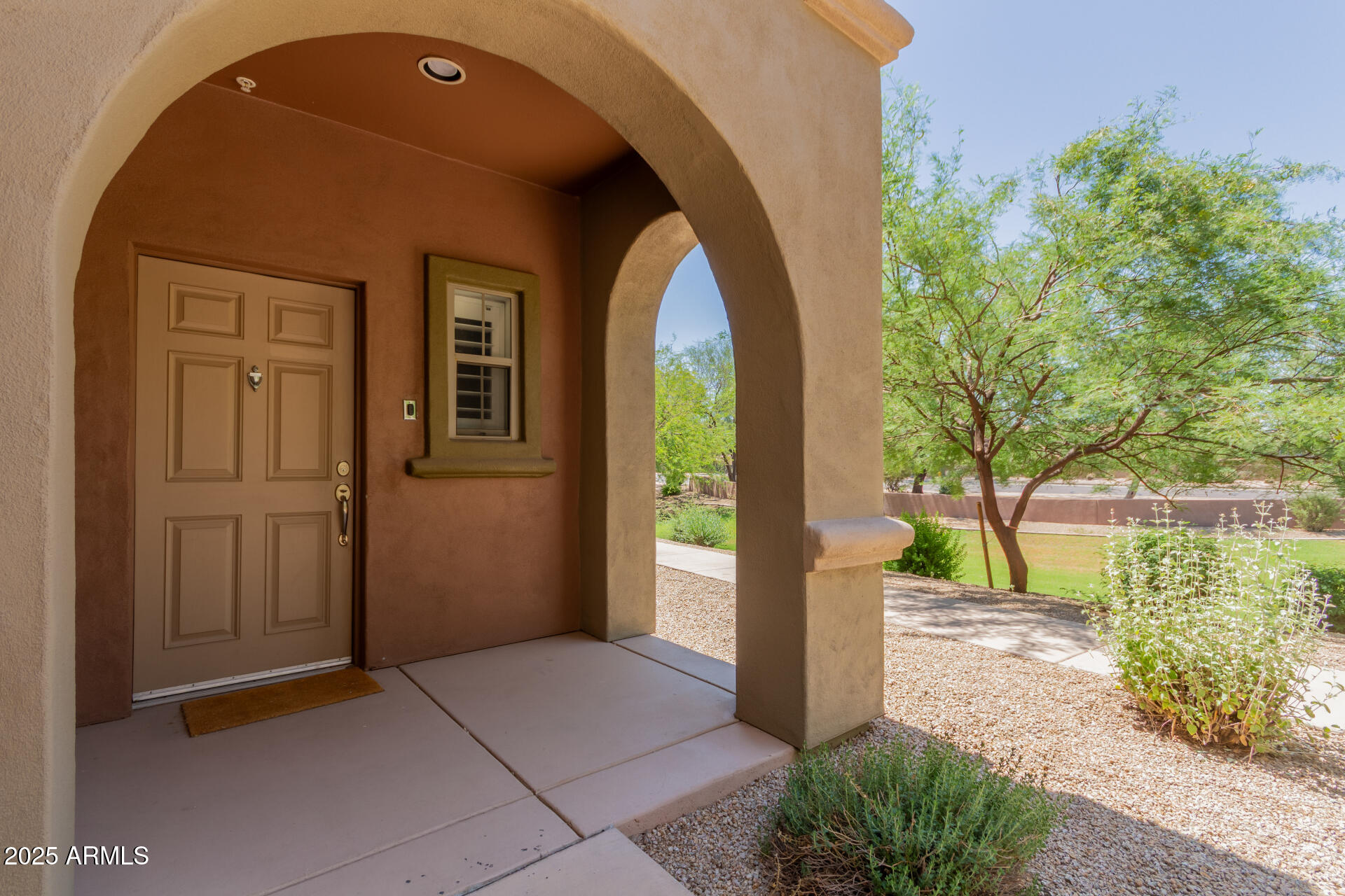 3935 East Rough Rider Road, Unit 1076 Phoenix, AZ 85050 - Photo 2 of 48 a front view of a house with a yard