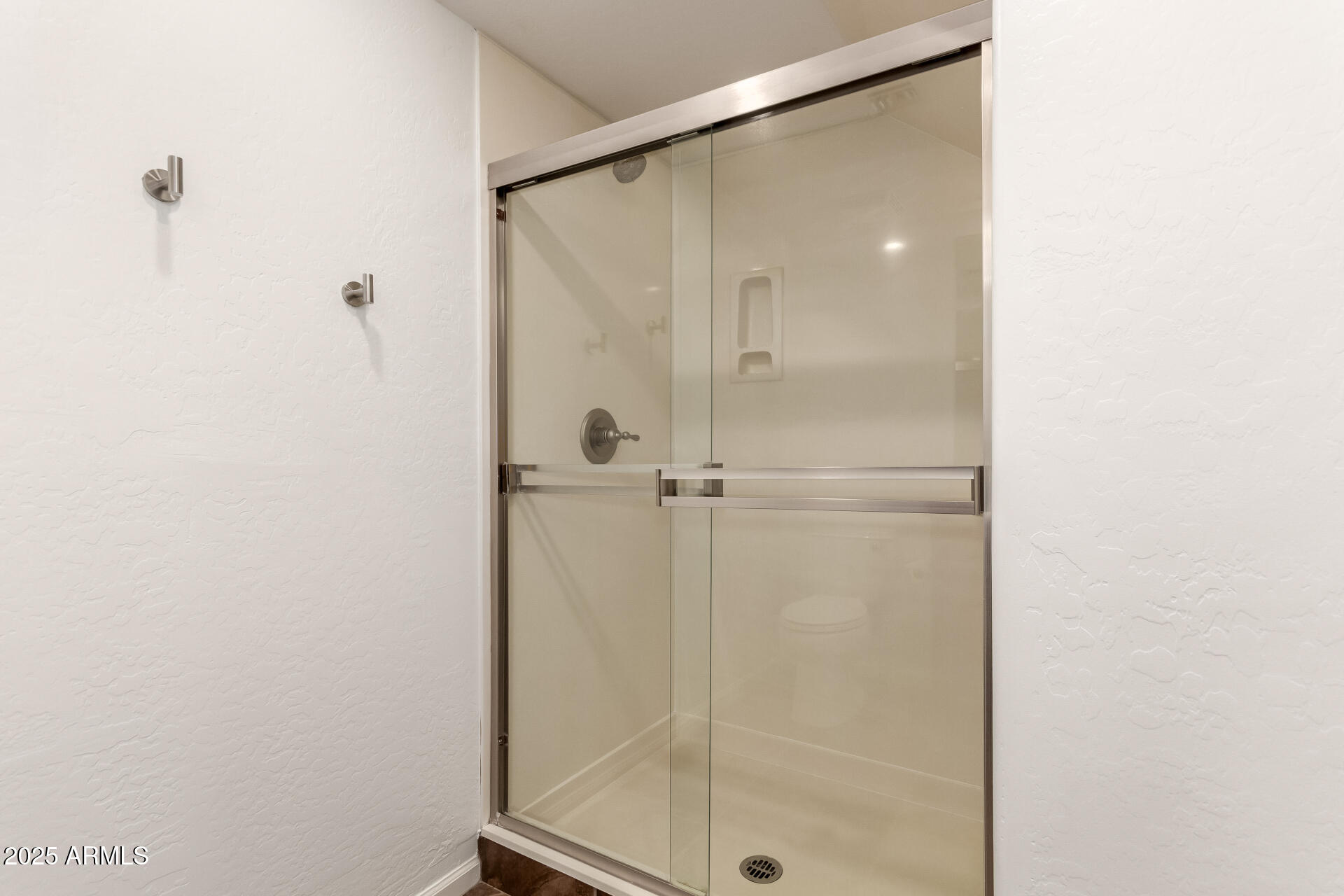 3935 East Rough Rider Road, Unit 1076 Phoenix, AZ 85050 - Photo 24 of 48 a bathroom with a glass shower door