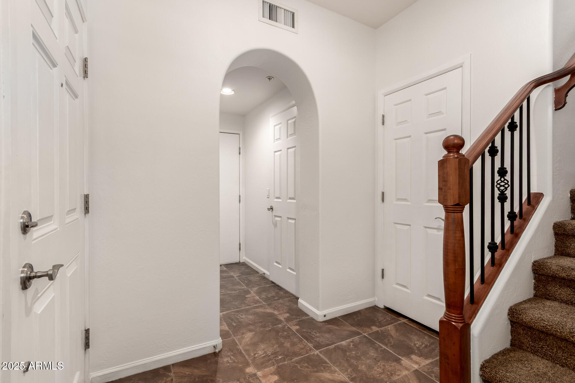 3935 East Rough Rider Road, Unit 1076 Phoenix, AZ 85050 - Photo 3 of 48 a view of a hallway with wooden floor and entryway