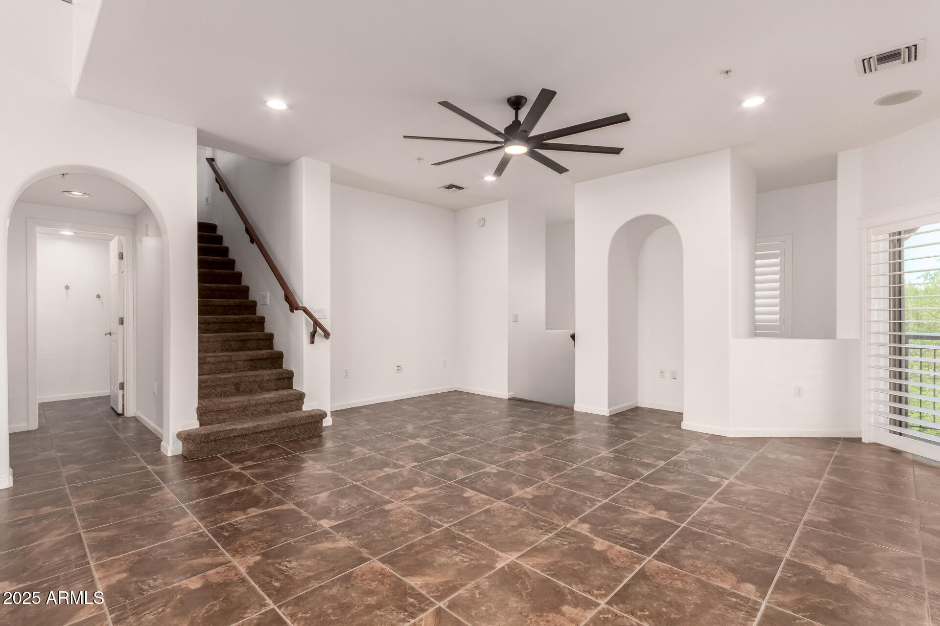 3935 East Rough Rider Road, Unit 1076 Phoenix, AZ 85050 - Photo 4 of 48 an empty room with windows and entryway