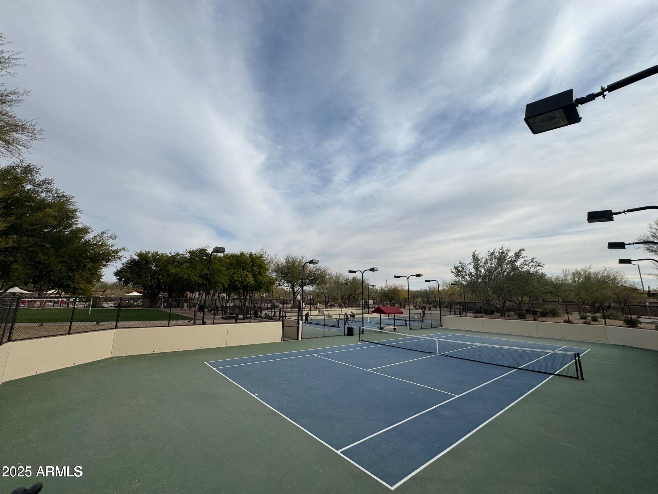 3935 East Rough Rider Road, Unit 1076 Phoenix, AZ 85050 - Photo 42 of 48 a view of a tennis court