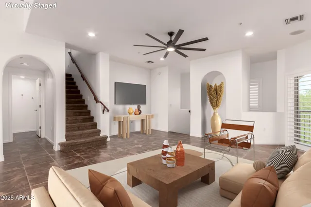 a living room with furniture and a clock