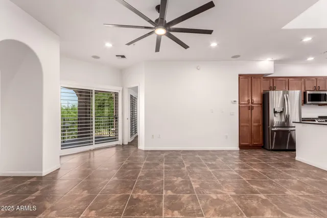 a view of kitchen with refrigerator cabinets and furniture