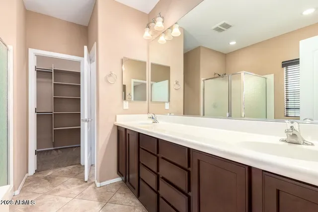 a bathroom with a sink double vanity and a shower