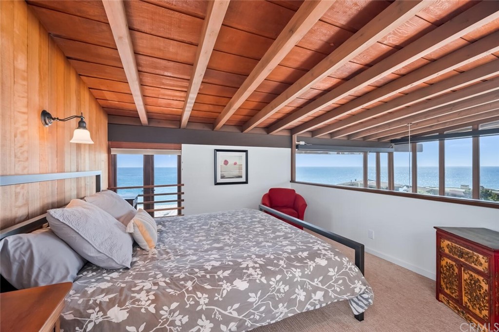 1944 Ocean Way Laguna Beach, CA 92651 - Photo 12 of 25 a bed sitting in a bedroom next to a window