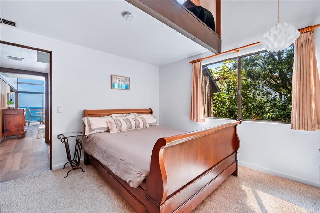 1944 Ocean Way Laguna Beach, CA 92651 - Photo 16 of 25 a bed room with a bed and a chair