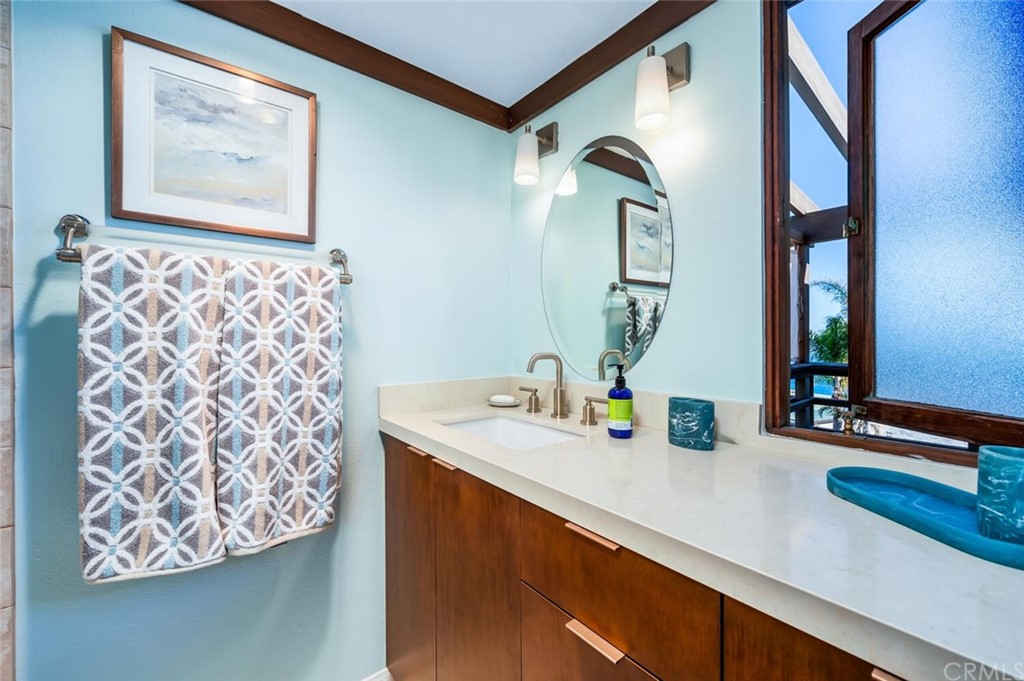 1944 Ocean Way Laguna Beach, CA 92651 - Photo 18 of 25 a bathroom with a sink a mirror and next to a window