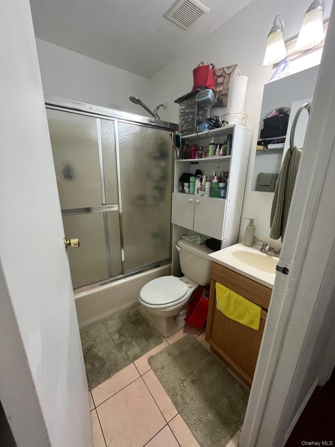 354 Beachview Street Copiague, NY 11726 - Photo 9 of 24 a bathroom with a toilet and a shower