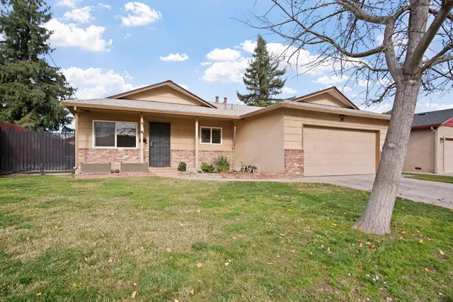 a front view of house with yard and green space