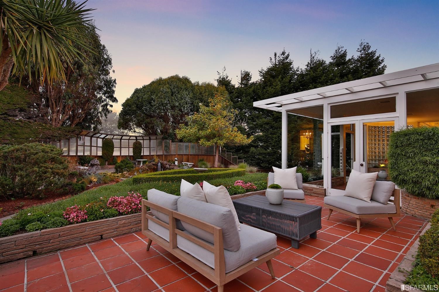 100 Stonecrest Drive San Francisco, CA 94132 - Photo 15 of 98 a view of a patio with couches table and chairs potted plants and palm trees