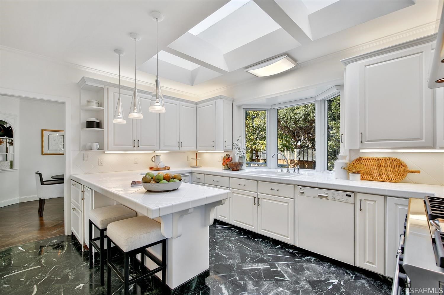 100 Stonecrest Drive San Francisco, CA 94132 - Photo 36 of 98 a kitchen with stainless steel appliances kitchen island a table and chairs in it
