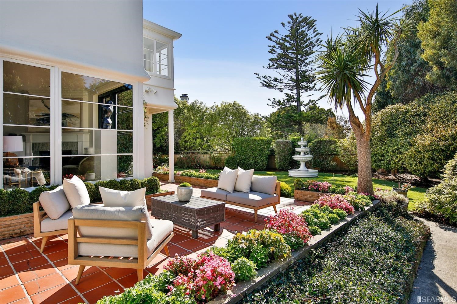 100 Stonecrest Drive San Francisco, CA 94132 - Photo 91 of 98 a view of a patio with couches table and chairs potted plants and palm tree