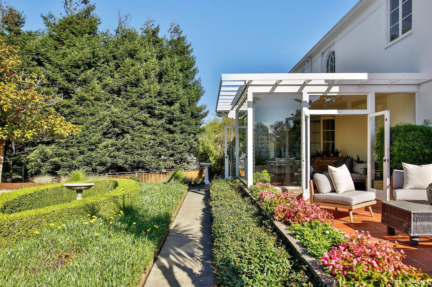 100 Stonecrest Drive San Francisco, CA 94132 - Photo 92 of 98 a view of a patio with table and chairs potted plants and floor to ceiling window and wooden fence