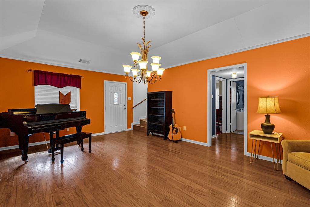 1495 Snider Lane Lucas, TX 75002 - Photo 14 of 39 a living room with furniture and a chandelier