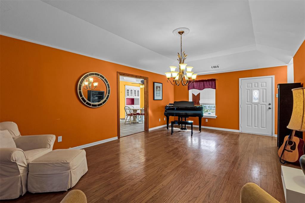 1495 Snider Lane Lucas, TX 75002 - Photo 15 of 39 a living room with furniture and a chandelier