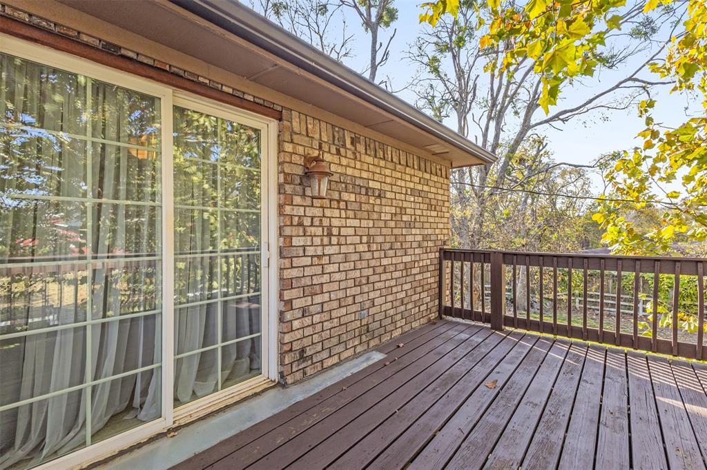 1495 Snider Lane Lucas, TX 75002 - Photo 27 of 39 a view of a balcony with a floor to ceiling window with wooden fence