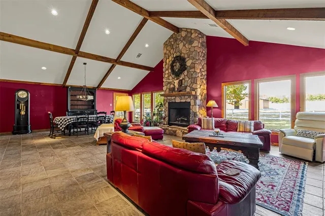 a living room with furniture a rug and a large window