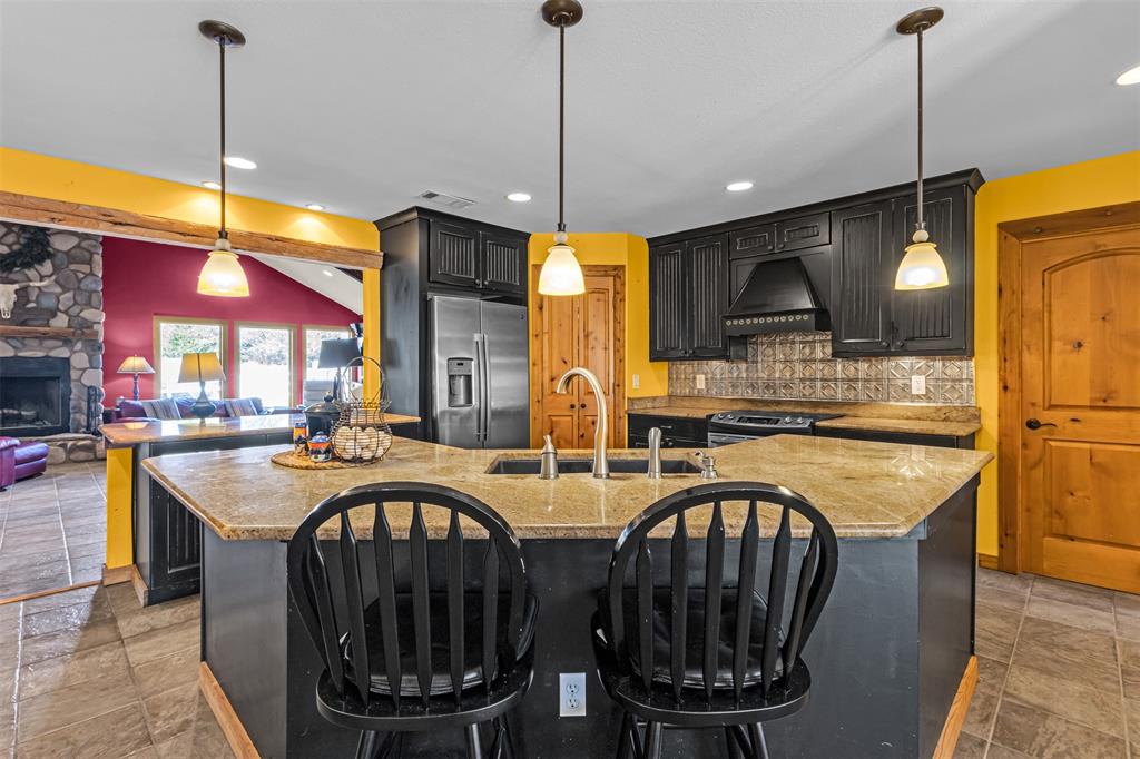 1495 Snider Lane Lucas, TX 75002 - Photo 39 of 39 a kitchen with stainless steel appliances granite countertop a stove a sink and a refrigerator