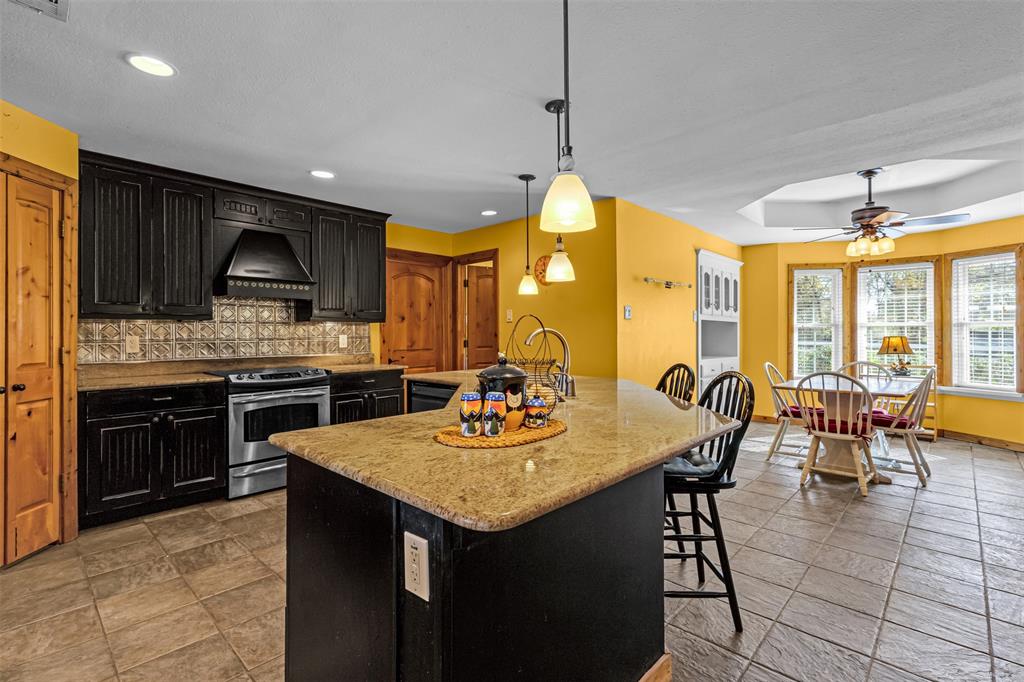 1495 Snider Lane Lucas, TX 75002 - Photo 8 of 39 a kitchen with a granite counter top space a sink stainless steel appliances and cabinets