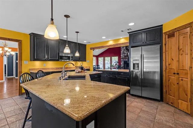 a view of a dining room with a table and chairs