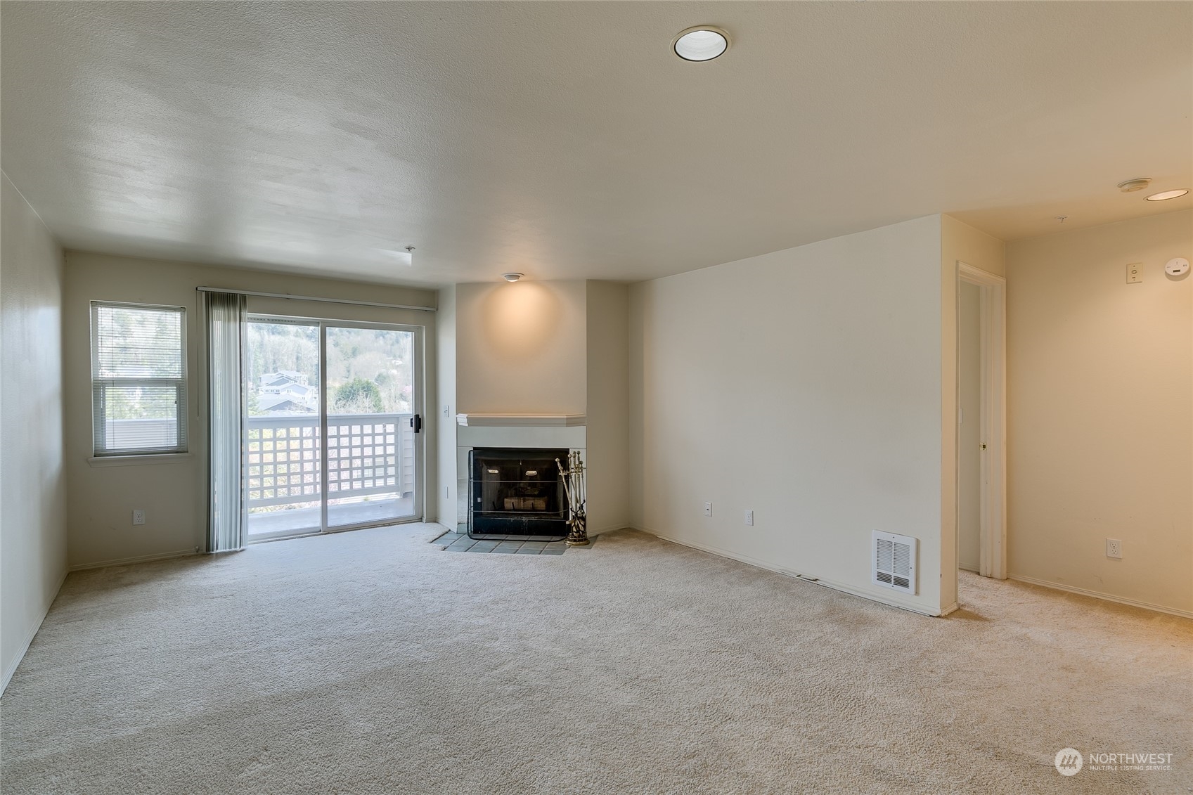 15711 Waynita Way Northeast, Unit H203 Bothell, WA 98011 - Photo 11 of 22 an empty room with furniture and a fireplace