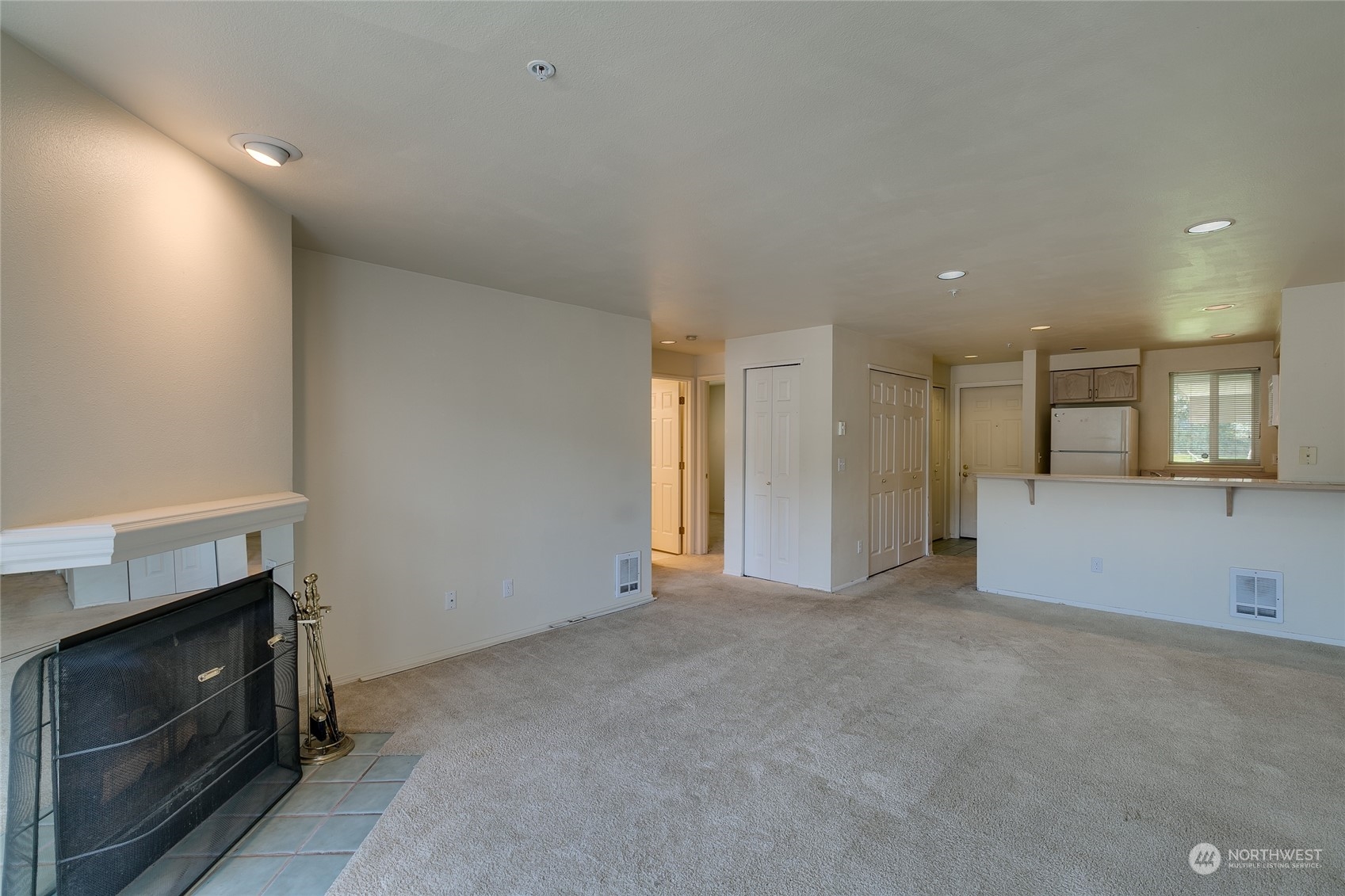 15711 Waynita Way Northeast, Unit H203 Bothell, WA 98011 - Photo 12 of 22 a view of an empty room with a fireplace and a window