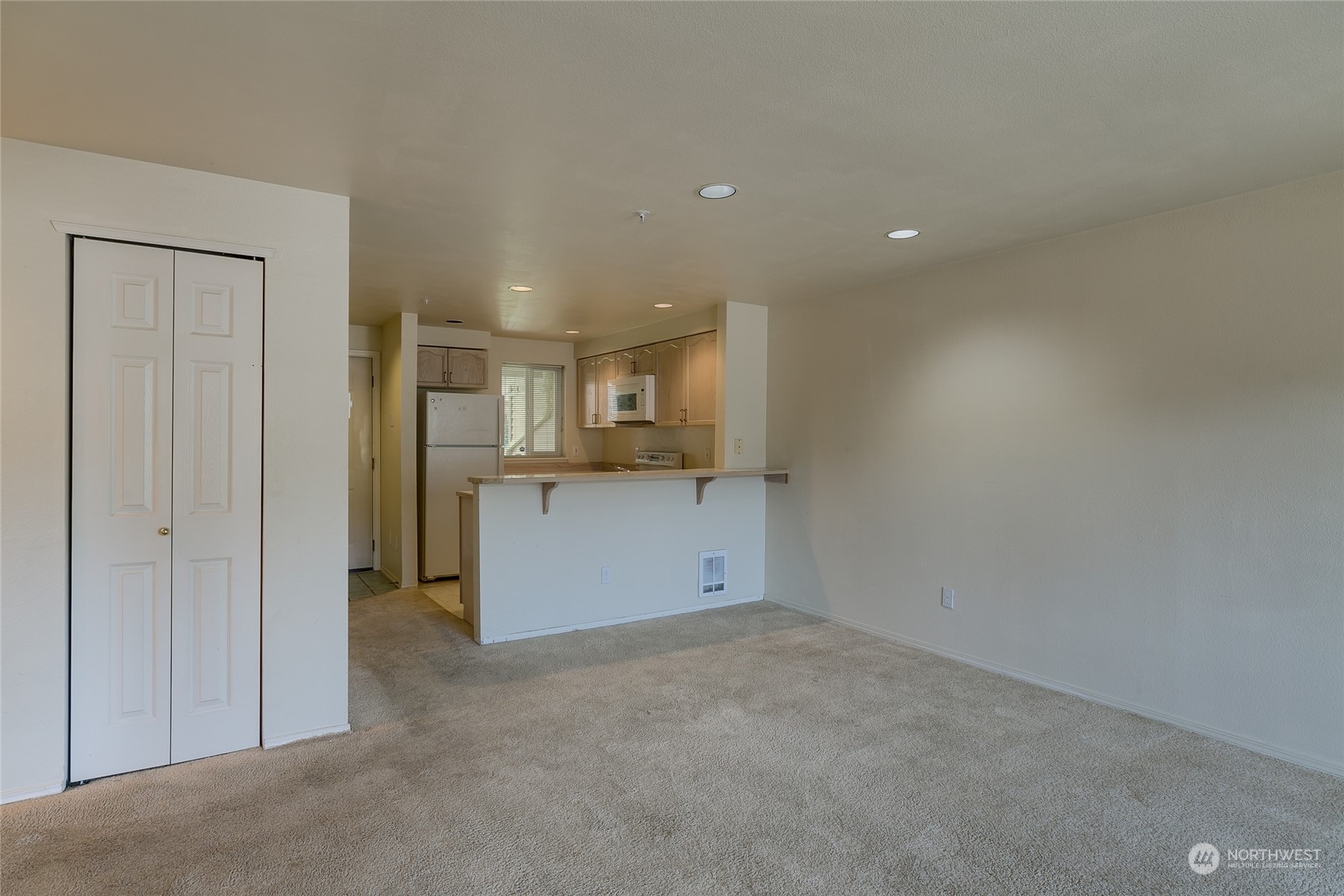 15711 Waynita Way Northeast, Unit H203 Bothell, WA 98011 - Photo 13 of 22 a view of kitchen and empty room