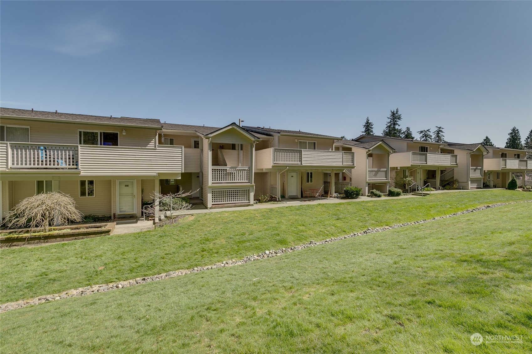 15711 Waynita Way Northeast, Unit H203 Bothell, WA 98011 - Photo 4 of 22 a front view of a house with a yard and garage