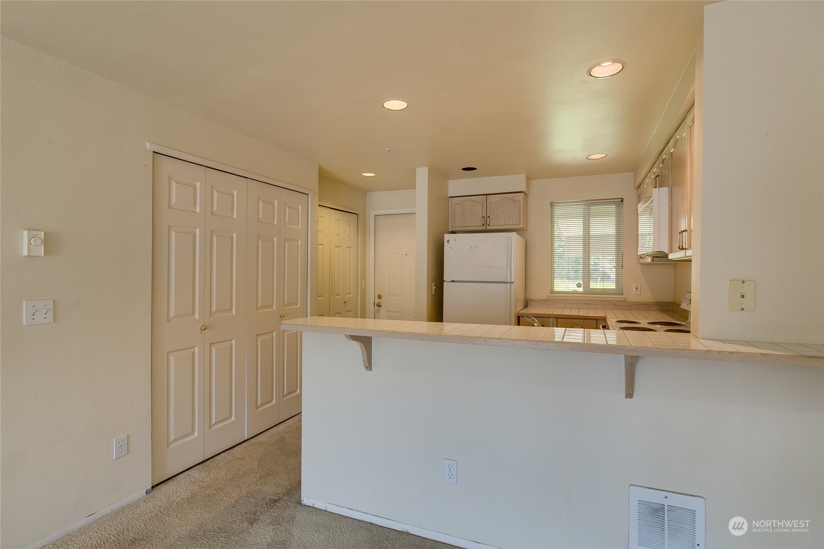 15711 Waynita Way Northeast, Unit H203 Bothell, WA 98011 - Photo 9 of 22 a view of a kitchen with a sink a window and wooden floor