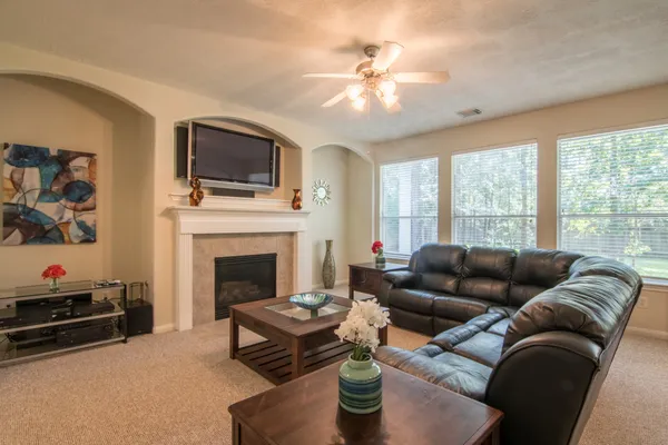 a living room with furniture fireplace and flat screen tv