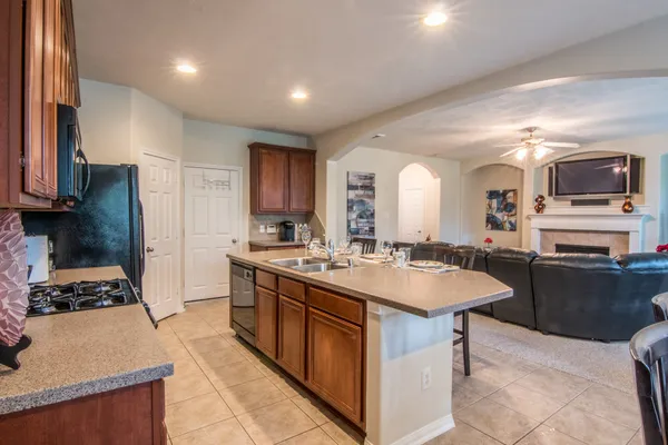 a kitchen with sink stove and refrigerator