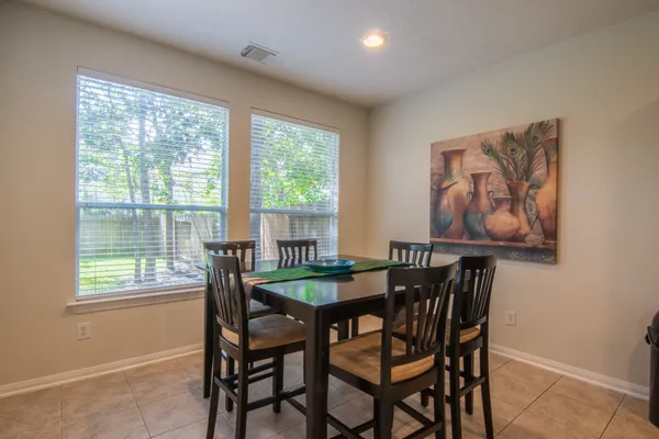 a dining room with furniture and window