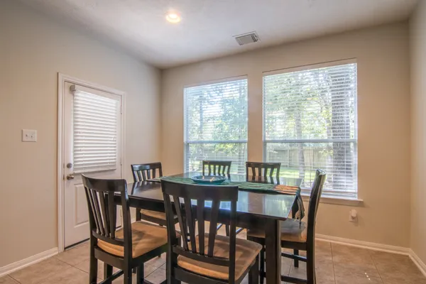 a view of a dining room with furniture and a window